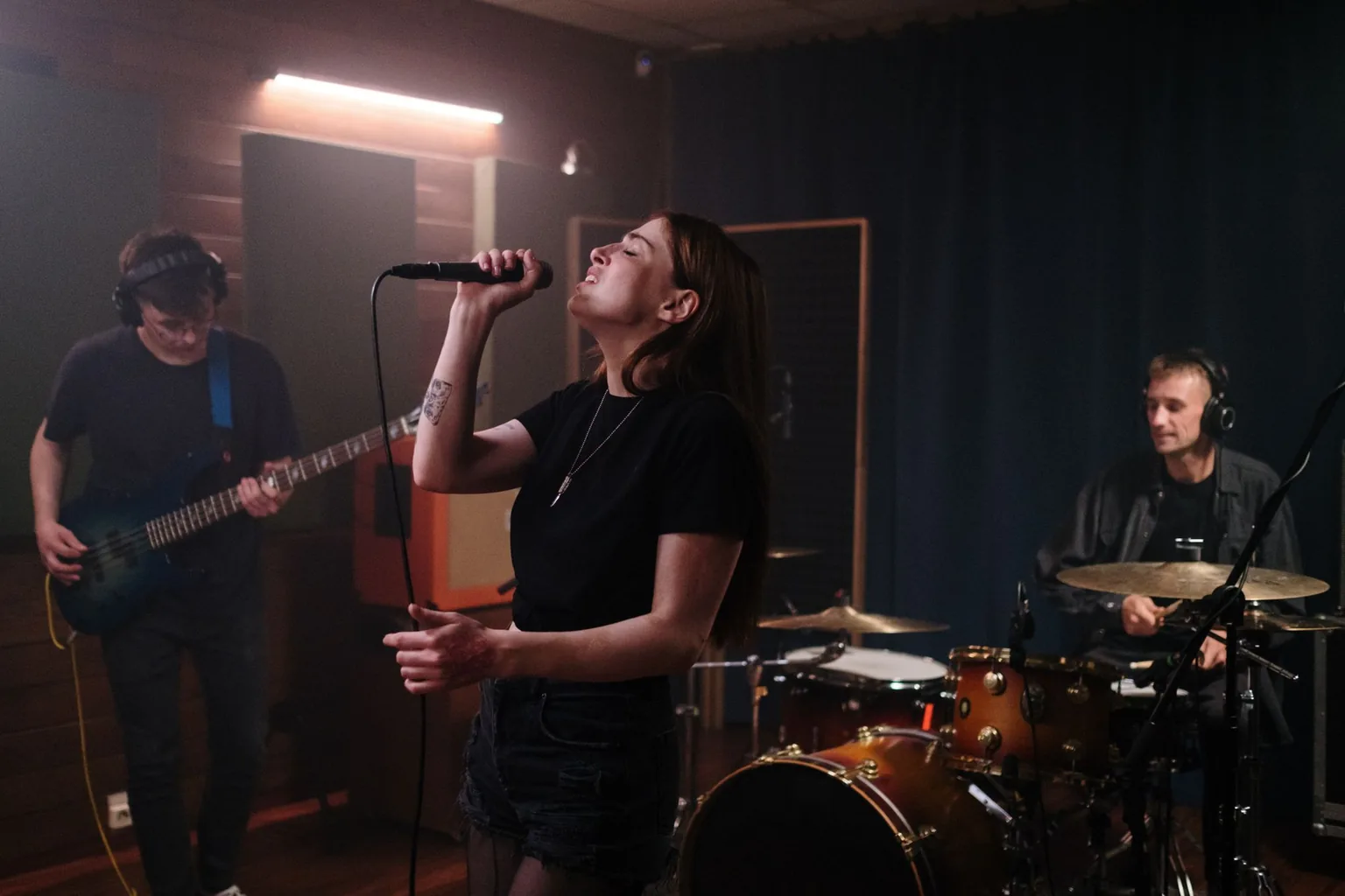 A bassist and a keyboard player at a late-night studio jam, filmed on a phone